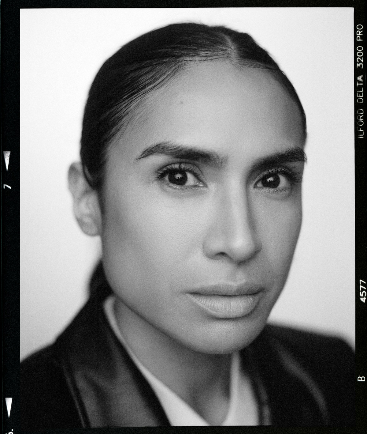 Black-and-white close-up portrait of Yasmine Seifi, with the original film border.